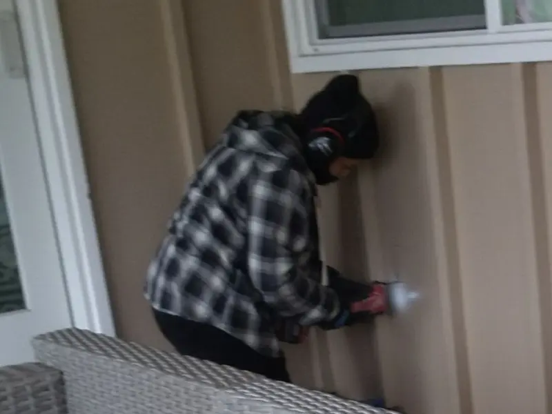 Professional electrician installing an exterior outlet in Sage